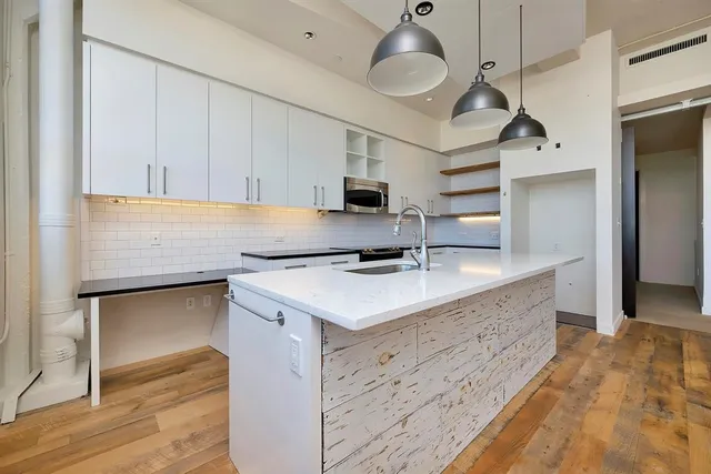 a kitchen with a sink cabinets and window