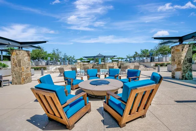 a view of a balcony with furniture and a floor to ceiling window