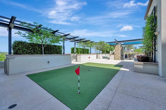 a view of a white house with a yard and potted plants
