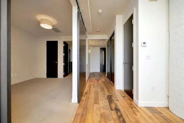 a view of a hallway with wooden floor