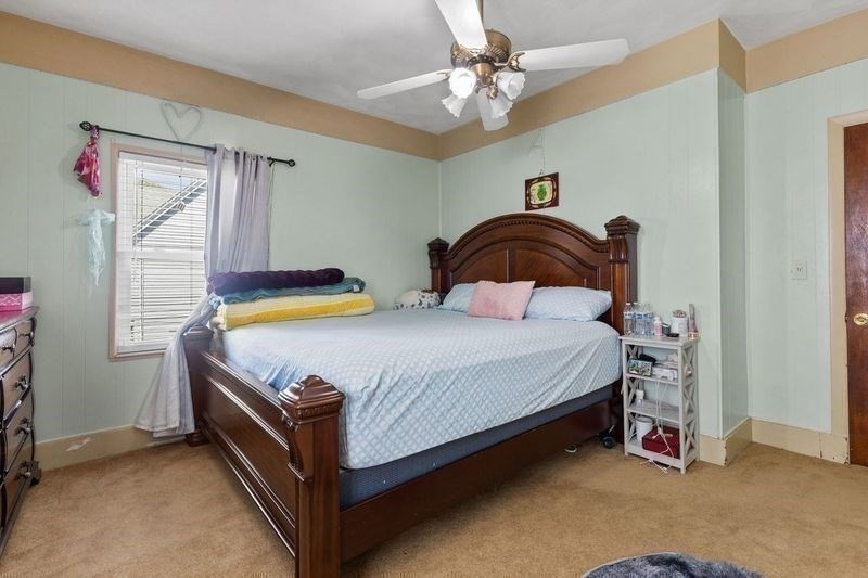 18 Baker Road Everett, MA 02149 - Photo 17 of 31 a bedroom with a bed and a chandelier