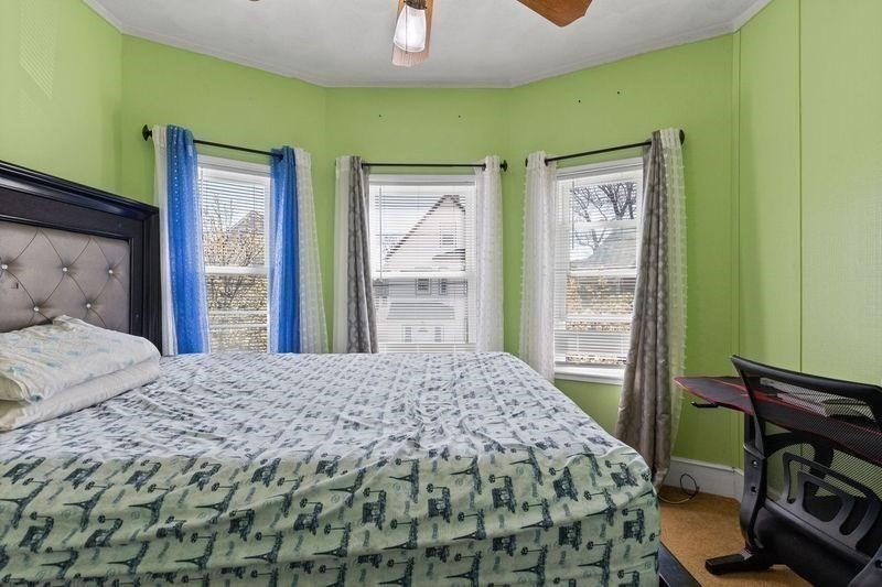 18 Baker Road Everett, MA 02149 - Photo 20 of 31 a bedroom with a bed and wooden floor