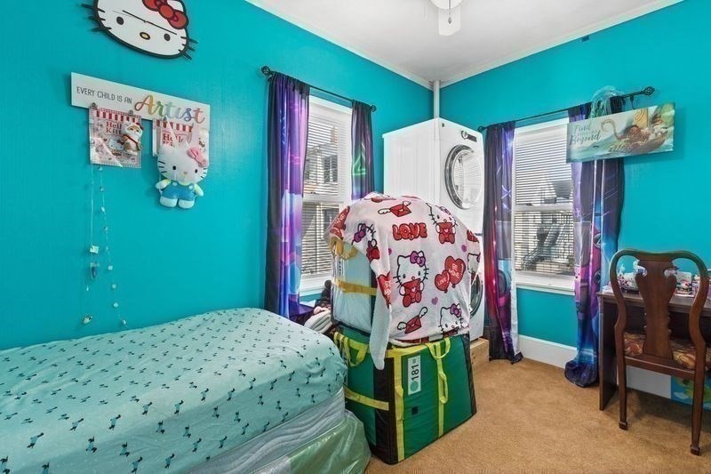 18 Baker Road Everett, MA 02149 - Photo 24 of 31 a bedroom with bed and a chandelier