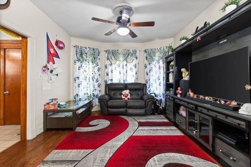18 Baker Road Everett, MA 02149 - Photo 6 of 31 a living room with furniture and a flat screen tv