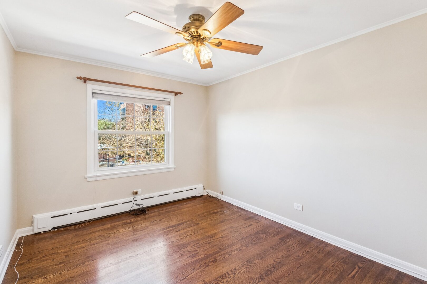 2252 Sherman Avenue, Unit 2 Evanston, IL 60201 - Photo 20 of 24 an empty room with a window and a ceiling fan