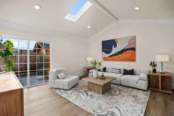 a living room with furniture and a potted plant