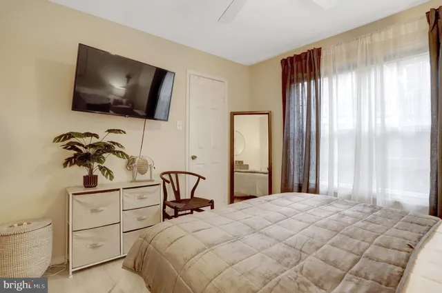 a bedroom with a bed and a flat screen tv
