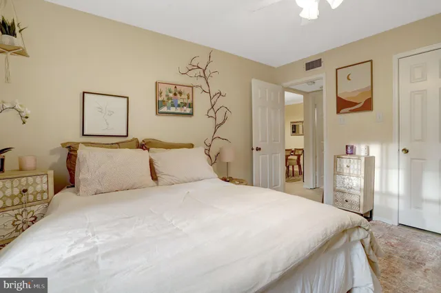 a bathroom with a granite countertop sink a toilet a mirror and shower