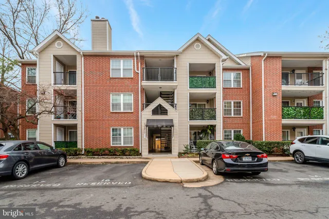a front view of a brick house with a yard