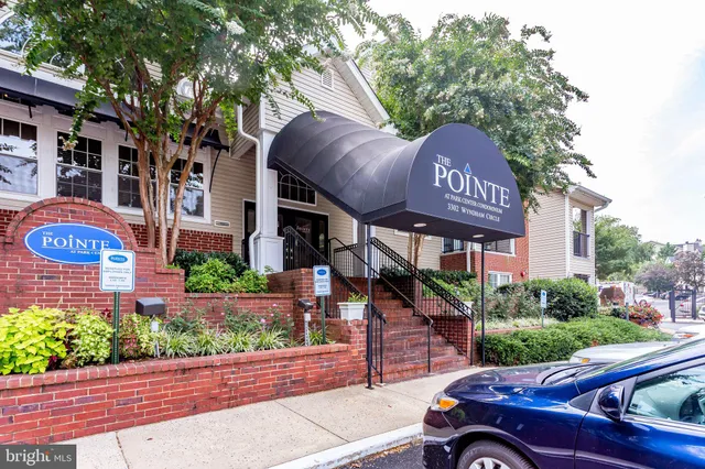 a view of a patio with couches table and chairs and potted plants