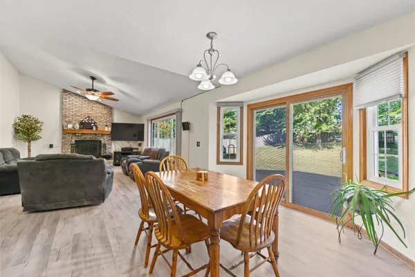 a dining room with furniture a chandelier and window