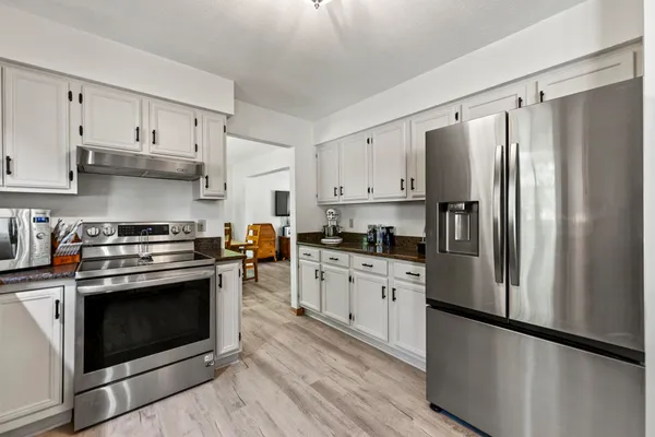 a kitchen with stainless steel appliances a refrigerator stove and sink