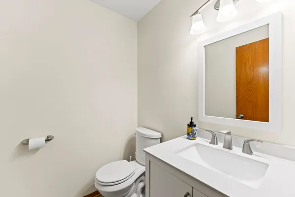 a bathroom with a sink a toilet and mirror