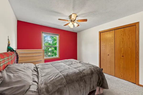 a bedroom with a bed and a window