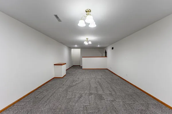 an empty room with a empty space and a ceiling fan