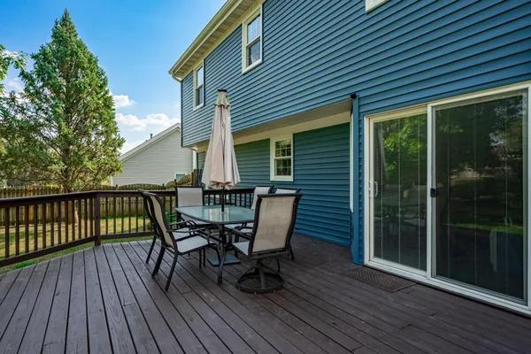 a view of a deck with wooden floor and outdoor seating