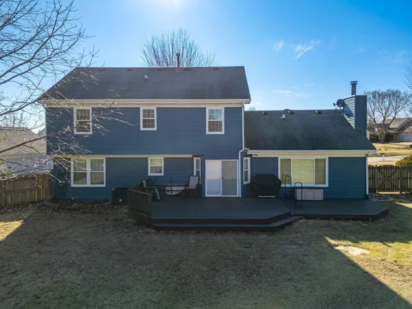 a view of a yard with wooden deck