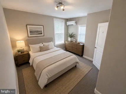 a bedroom with a bed and a mirror