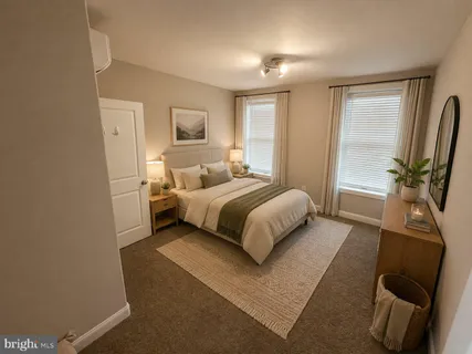 a bedroom with a bed wooden floor and mirror