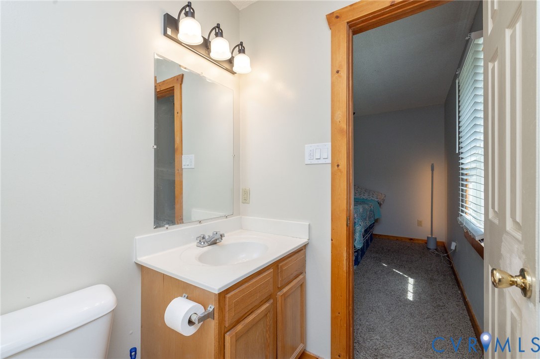 460 Horseshoe Road Jarratt, VA 23867 - Photo 12 of 24 a bathroom with a sink a toilet and a mirror
