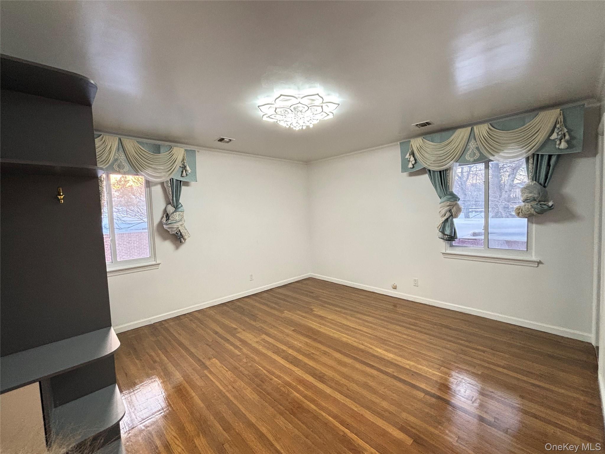 105 Seaman Road Jericho, NY 11753 - Photo 14 of 22 a view of empty room with wooden floor