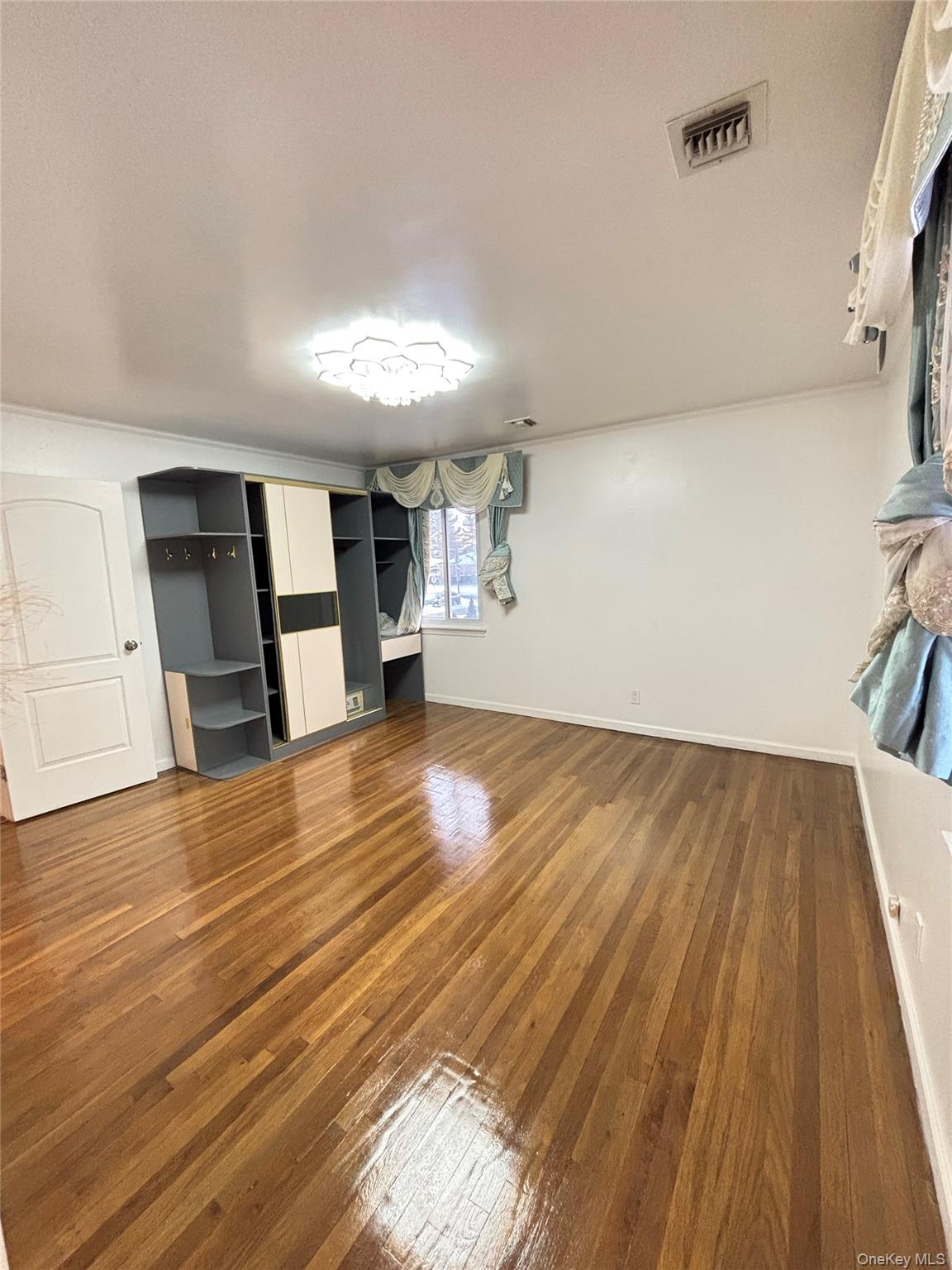 105 Seaman Road Jericho, NY 11753 - Photo 15 of 22 a view of empty room with wooden floor