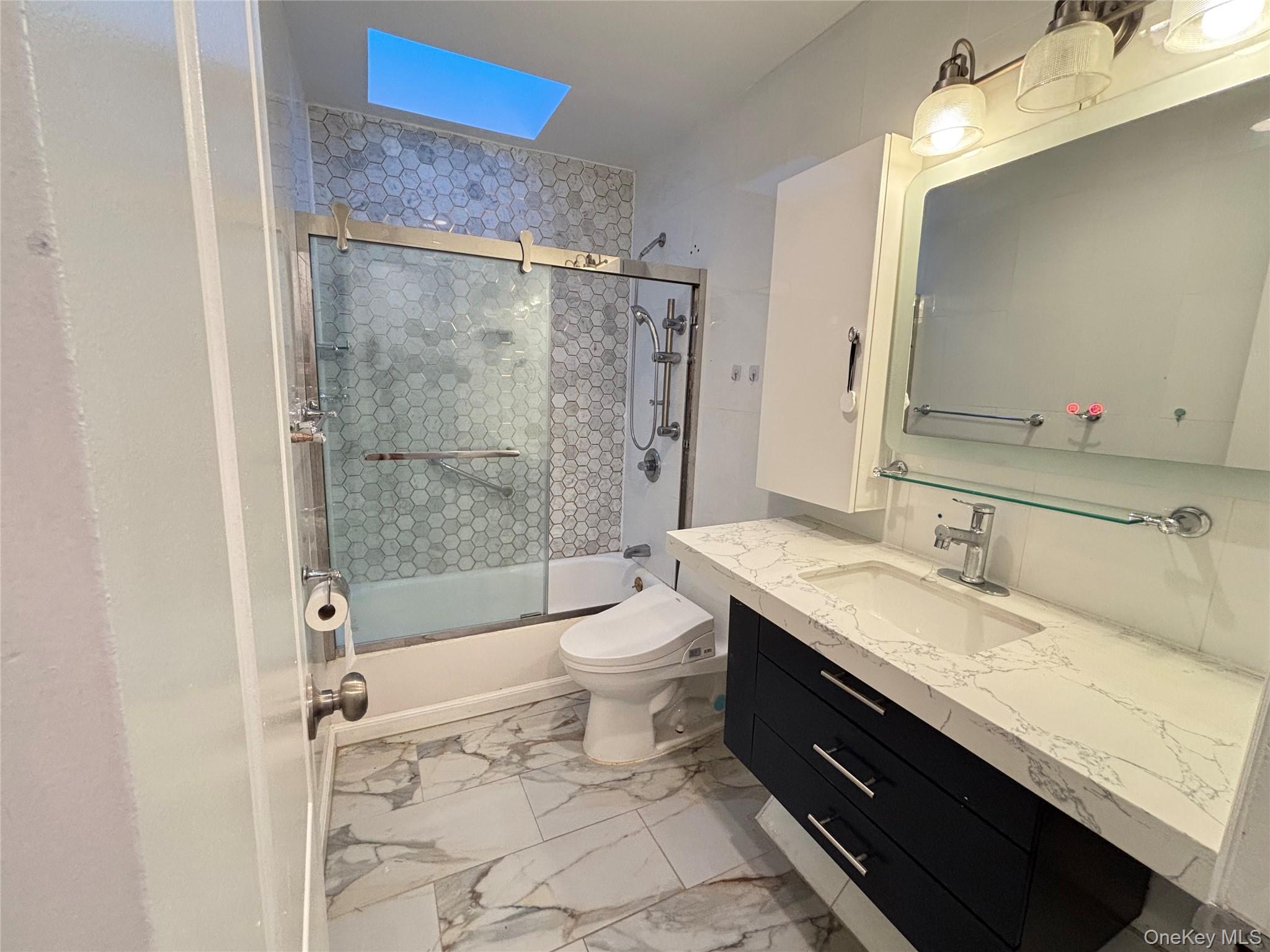 105 Seaman Road Jericho, NY 11753 - Photo 16 of 22 a bathroom with a granite countertop sink toilet and shower