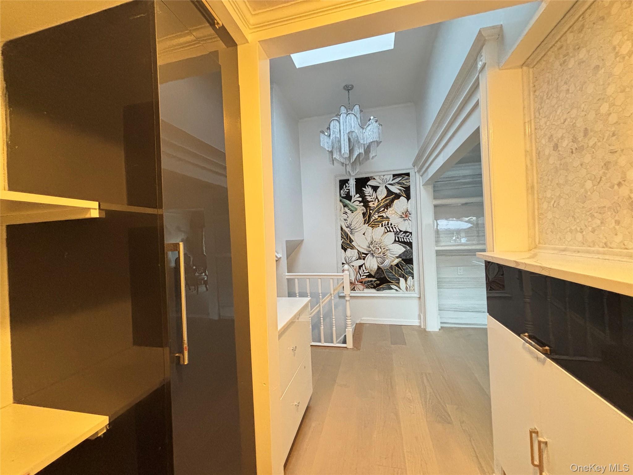 105 Seaman Road Jericho, NY 11753 - Photo 17 of 22 a view of a hallway with wooden floor and a living room