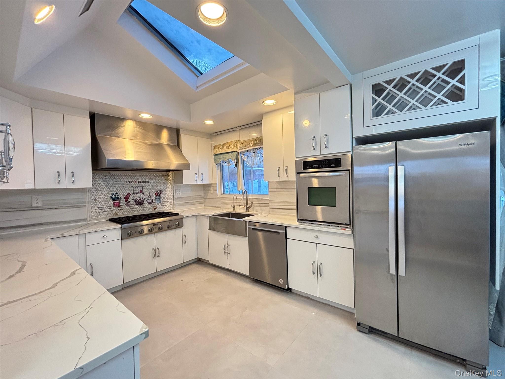 105 Seaman Road Jericho, NY 11753 - Photo 2 of 22 a kitchen with stainless steel appliances granite countertop a refrigerator sink and stove