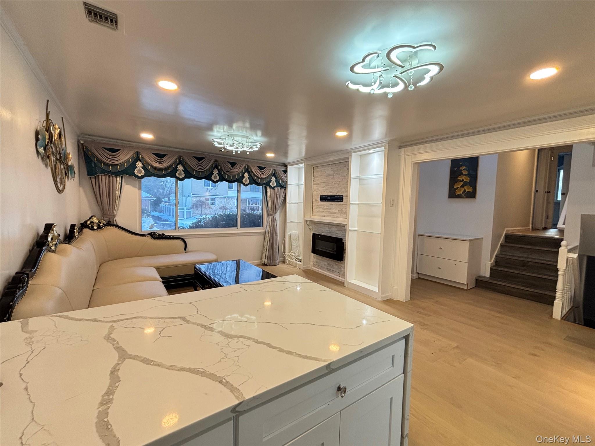 105 Seaman Road Jericho, NY 11753 - Photo 4 of 22 a bedroom with a bed and a chandelier