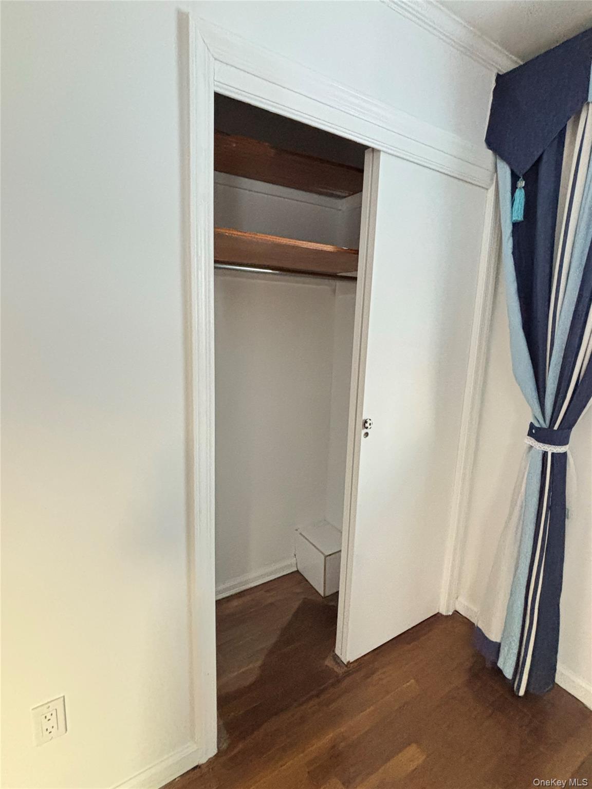 105 Seaman Road Jericho, NY 11753 - Photo 9 of 22 a view of an empty room with wooden floor and a window