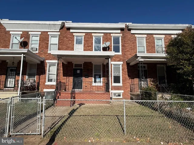 front view of a brick house with a patio