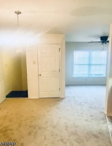 an empty room with cabinet and mirrors