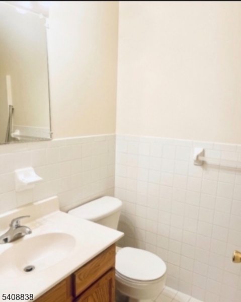 64 Isabella Avenue Newark, NJ 07106 - Photo 5 of 8 a bathroom with a sink a toilet and a mirror