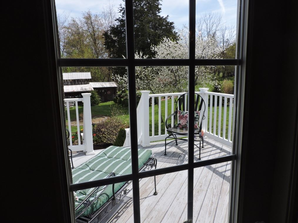 68 Purple Cow Road Waynesboro, VA 22980 - Photo 5 of 22 a view of a balcony with floor to ceiling windows and wooden floor