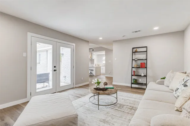 a living room with furniture and wooden floor