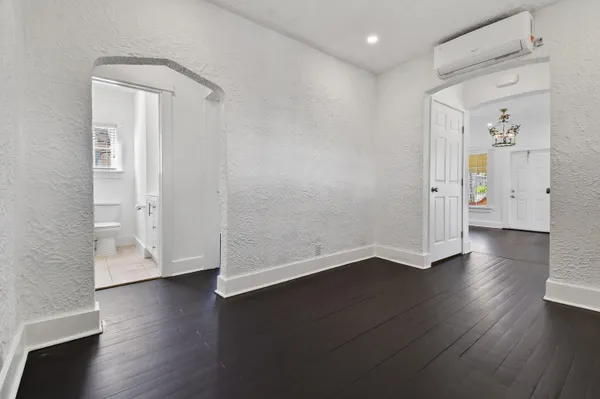 an empty room with wooden floor and a window