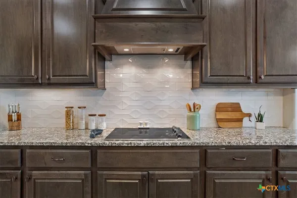 a stove top oven sitting inside of a kitchen