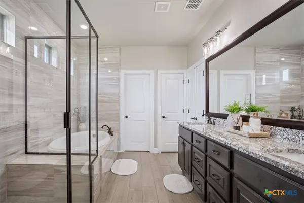 a bathroom with a granite countertop sink and a mirror