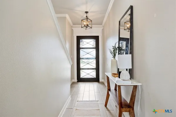 a view of an entryway with wooden floor and front door
