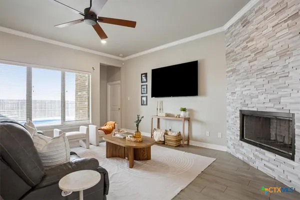 a living room with furniture a fireplace and a flat screen tv