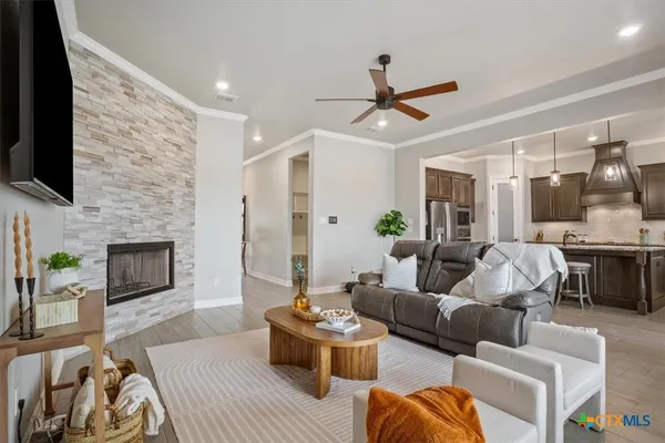 a living room with furniture a fireplace and a flat screen tv