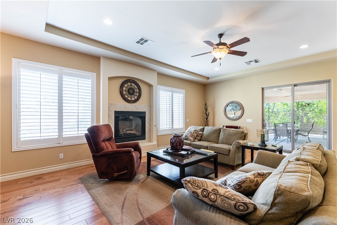 3661 Riley Ann Avenue Las Vegas, NV 89139 - Photo 10 of 42 Hardwood floors and a cozy fireplace create a warm and inviting living space.