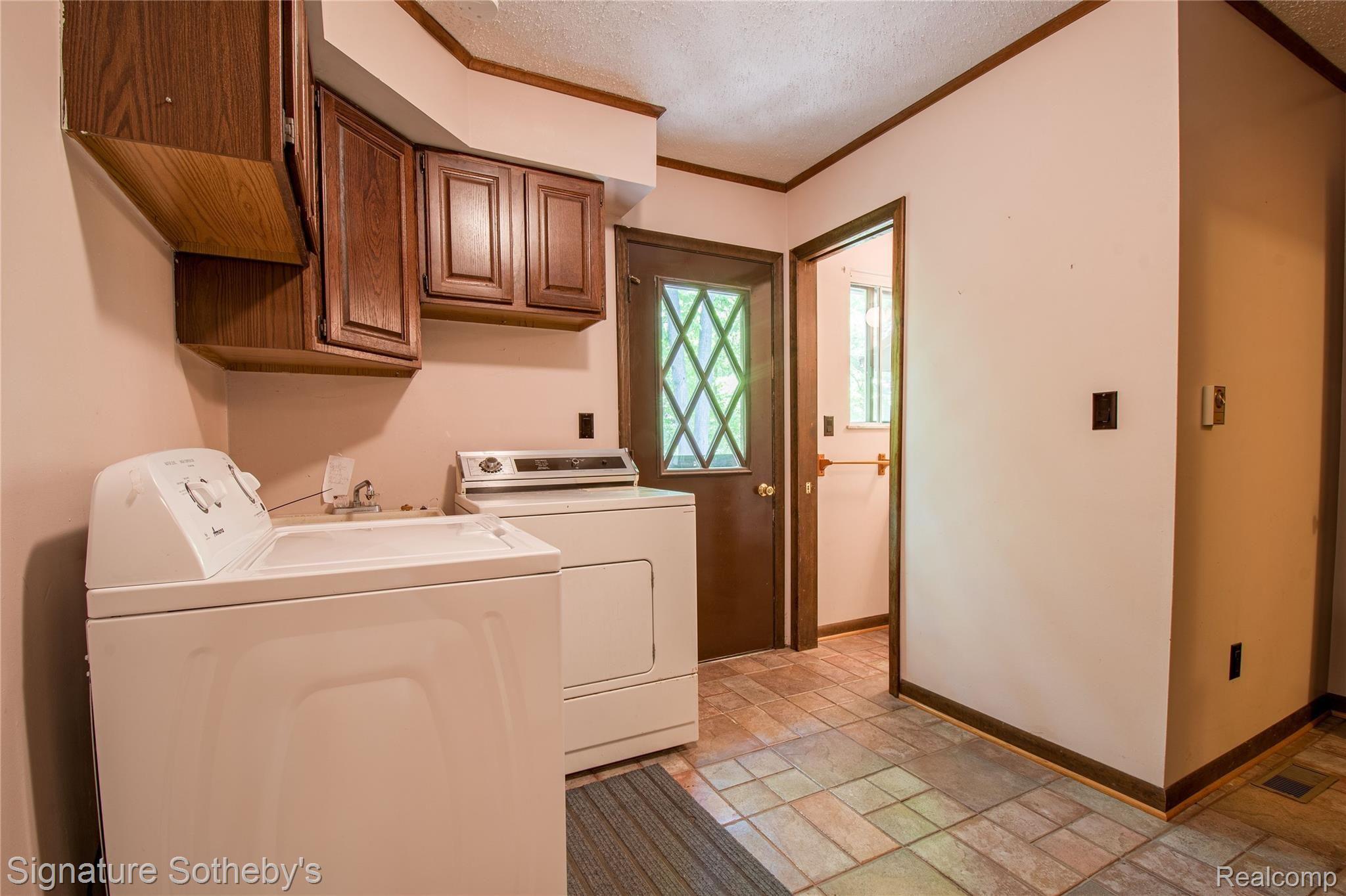 11920 Read Road Fenton, MI 48430 - Photo 21 of 43 First floor laundry with door to backyard deck