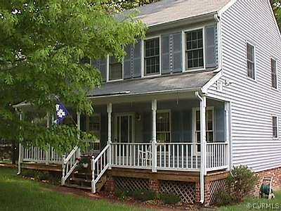 a view of a house with a deck and a garden