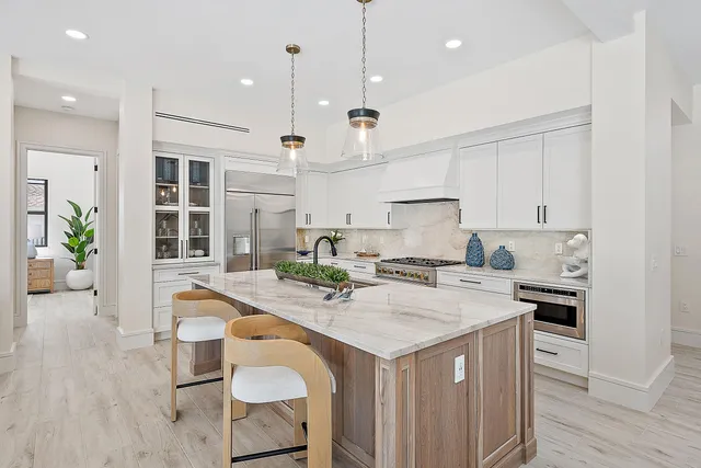 a bathroom with a granite countertop toilet sink and mirror