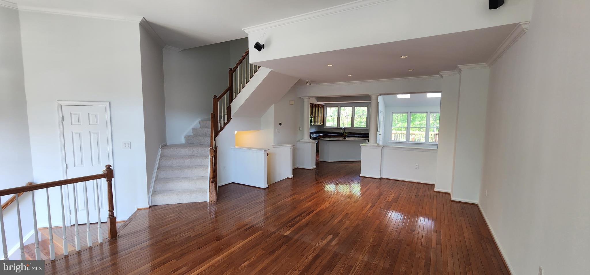 20320 Burnley Square Sterling, VA 20165 - Photo 2 of 22 wooden floor in an empty room with a kitchen