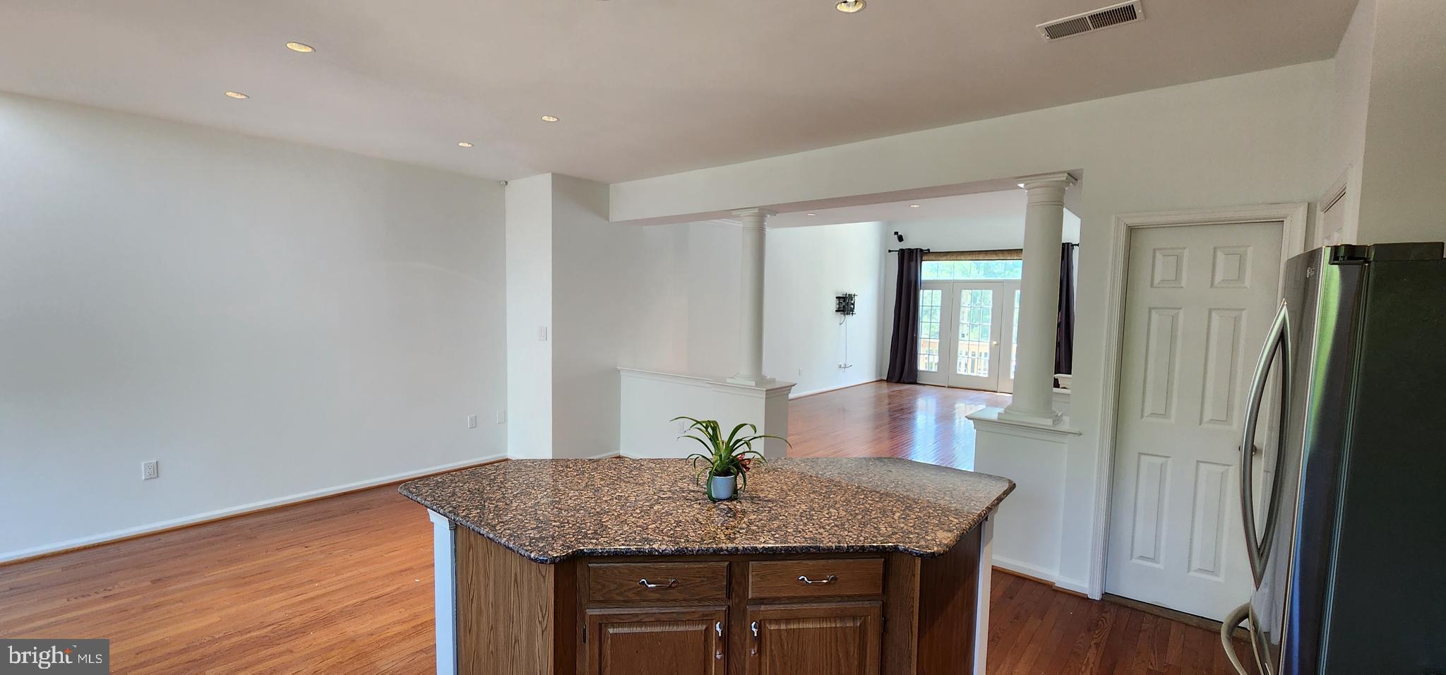 20320 Burnley Square Sterling, VA 20165 - Photo 5 of 22 a view of a kitchen with granite countertop a refrigerator and wooden floor