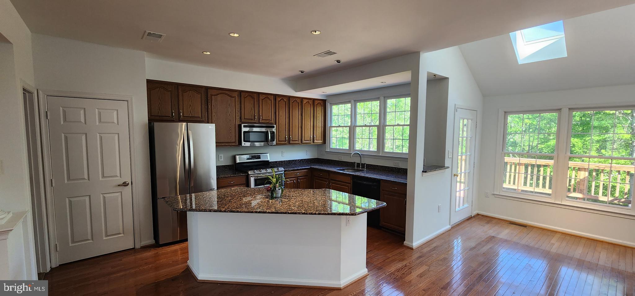 20320 Burnley Square Sterling, VA 20165 - Photo 6 of 22 a kitchen with granite countertop a refrigerator and a sink