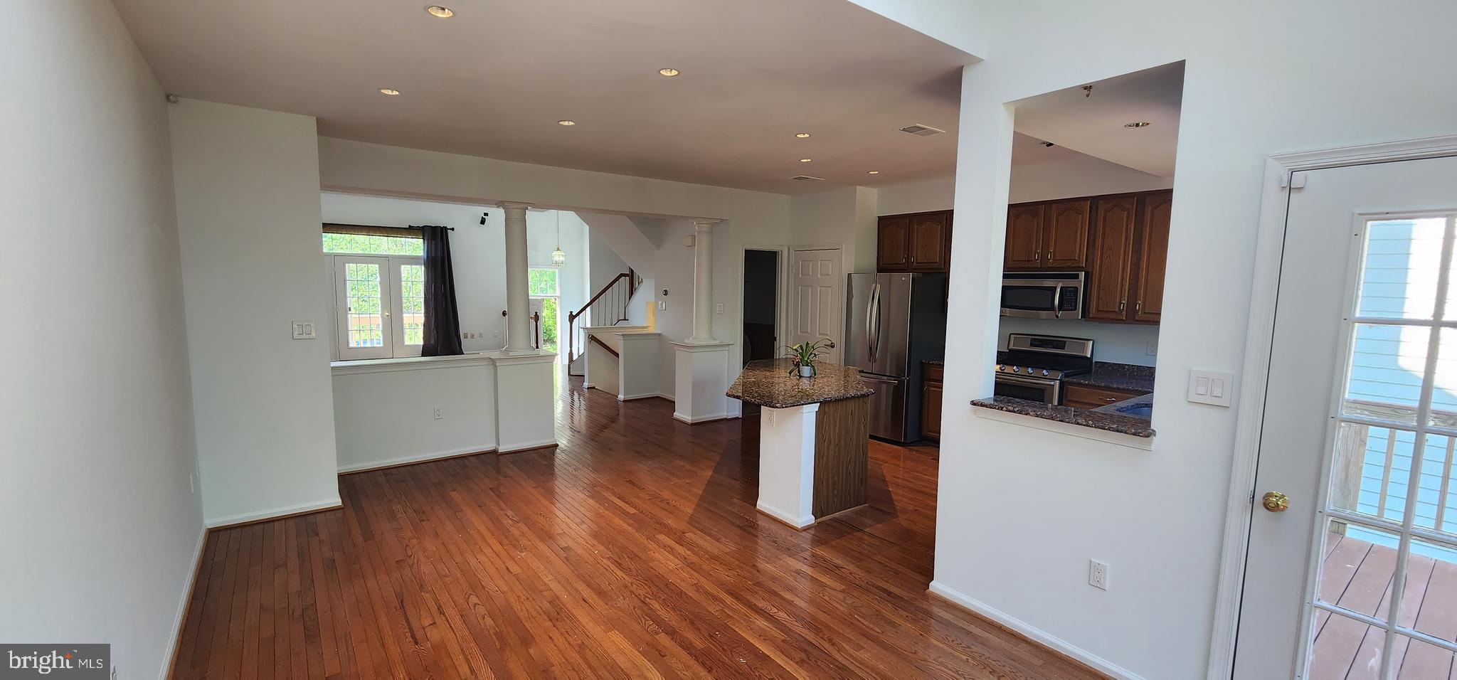 20320 Burnley Square Sterling, VA 20165 - Photo 9 of 22 a view of a living room with wooden floor and a kitchen